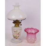 A Victorian brass mounted oil lamp with white opaque glass footed reservoir,