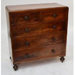 A mahogany chest of two short and three long graduated drawers on turned bun feet with castors,