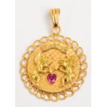 An unusual 18ct yellow gold pendant with pierced border and central engraved circular panel set