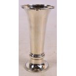 A large George V hallmarked silver loaded vase with beaded rim, tapering body and spreading foot,