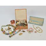 A small weight of costume jewellery including various necklaces, brooches and pendants,