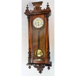 A late 19th century walnut and beech Vienna style twin weight wall clock,
