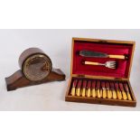 A walnut cased set of twelve fish knives, forks and servers, and a dome topped mantel clock (2).