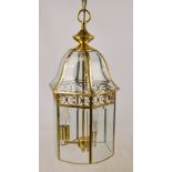 A large brass hexagonal lantern with plain bevelled glass panels,