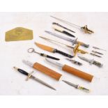 A quantity of letter openers/paper knives in the form of swords and daggers,