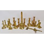 A collection of late 18th century to 19th century brass candlesticks including eight pairs,