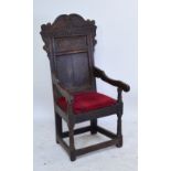 A 17th century oak Wainscott chair, the shaped carved top rail inscribed "1646", with panel back,