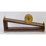 A 20th century walnut and brass rolling gravity clock,