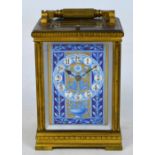 A late 19th century French half hour repeating brass carriage clock with enamel painted panels in