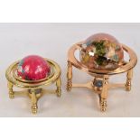 Two modern hardstone globes in brass gimballed frames, the larger height 21cm (2).