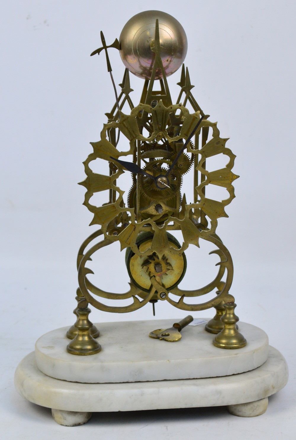 A late 19th century brass skeleton clock with pierced Gothic case,