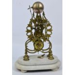 A late 19th century brass skeleton clock with pierced Gothic case,