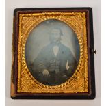 A Victorian leather cased ambrotype depicting probably Prince Albert within engraved yellow metal