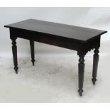 A Victorian Gothic mahogany side table with shaped apron,