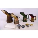 A small collection of automobilia comprising four oil jugs including Castrol, Mobil oil etc,