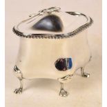 A George V hallmarked silver tea canister of shaped lozenge form with hinged lid and rope twist