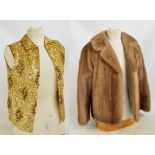 A pale mink jacket with shaped collar and button feature cuffs, with coffee silk lining,
