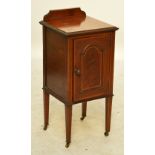 An Edwardian mahogany and satinwood crossbanded single door bedside cupboard raised on square