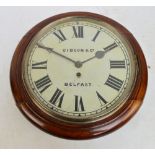 A late 19th century stained beech circular wall clock with painted metal dial set with numerals