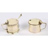 A George V hallmarked silver mustard pot of octagonal form with angled handle and scallop shaped