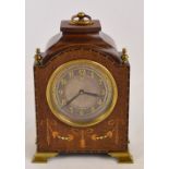 A small Edwardian mahogany and inlaid mantel clock with silvered dial set with Arabic numerals