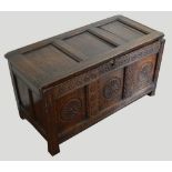 A late 18th/early 19th century oak panelled coffer with possibly later carved front three panels,