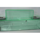 A perspex display unit of step design with inner shelf and small central door with lock, 43 x 98cm.
