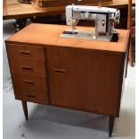 A sewing machine in a non-matching cabinet.