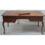 A 20th century walnut writing desk of rectangular form, length approx 160cm (af).