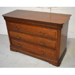 A mahogany three drawer chest of drawers with chamfered corners.