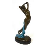 A hot cast bronze in Art Deco style of a naked female dancing figure with blue flowing robe on a