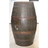 An early 20th century large wooden barrel with metal bands, height 146cm.