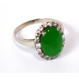 A white metal diamond and jade ring,