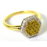 A 9ct yellow gold diamond and fancy yellow diamond ring with hexagonal raised central platform,