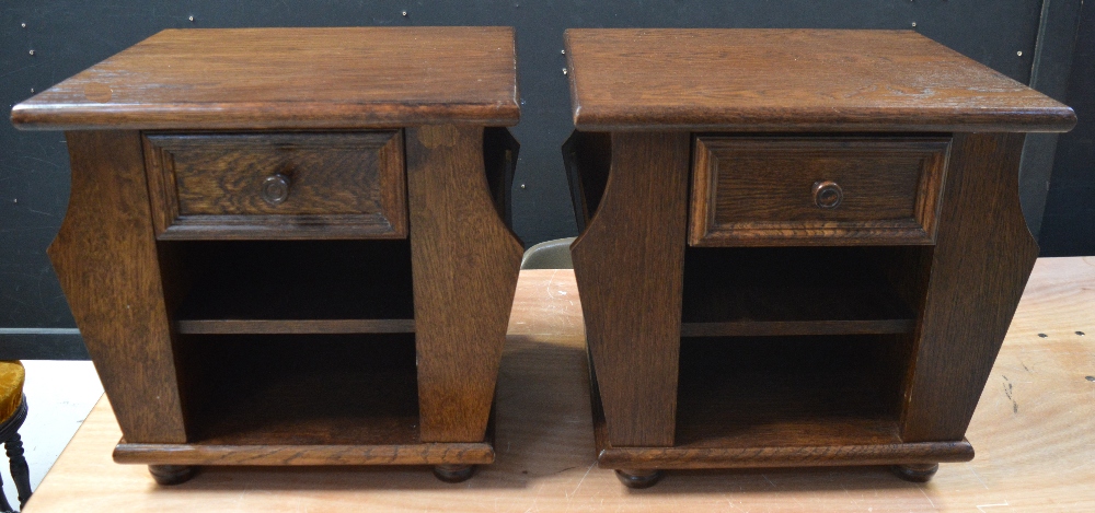 A pair of 20th century oak side tables, with single drawer above open shelves,