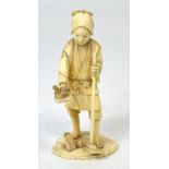 A Japanese Meiji period carved ivory okimono modelled as a labourer leaning on a long shafted tool,