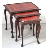 A nest of three reproduction leather topped occasional tables, width of largest 60cm.