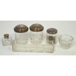 A quantity of dressing table jars and inkwells with silver and silver plated tops,