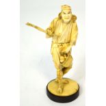 A Japanese Meiji period carved ivory okimono modelled as a gentleman with basket upon his back and