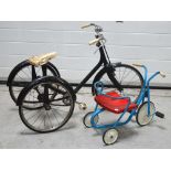 A vintage black-painted child's tricycle and a similar smaller blue and red tricycle (2).