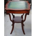 A reproduction mahogany leather topped side table with lower shelf on splayed carved legs,