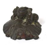 A c.1900 Chinese bronzed figure of a warrior creeping up on an oni, width approx 7cm.
