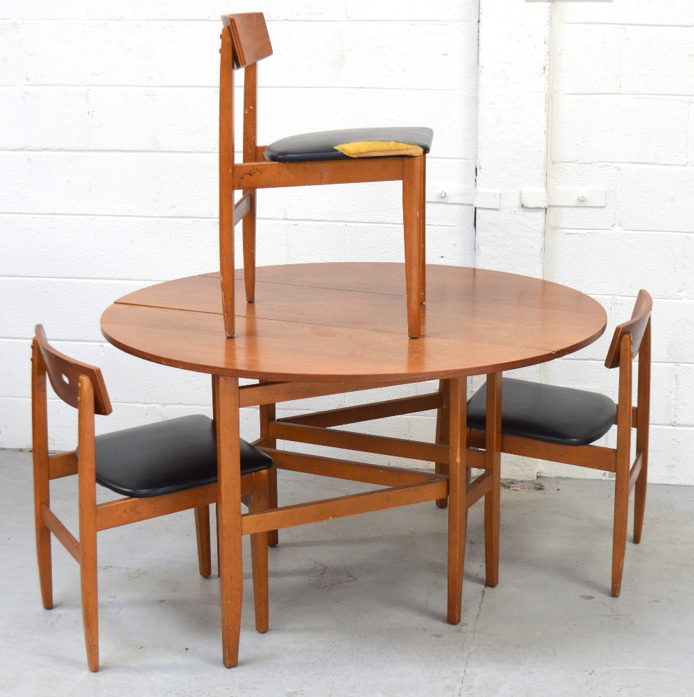 A G-Plan style drop-leaf dining table on tapered legs and a set of three matching chairs (4).