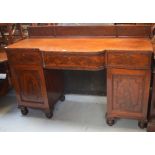 A 19th century walnut breakfast buffet with stepped shaped front and door either side of a central
