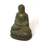 A 20th century Chinese embossed metal figure of seated Buddha on lotus leaf decorated base,