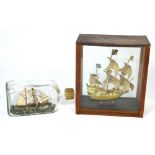 A ship model in a bottle inscribed 'Brigantine', length 20cm and a further ship's model in case,