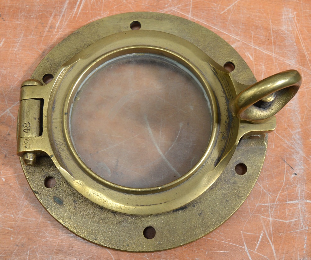 A brass ship's porthole, diameter 25cm.