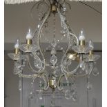 A bronzed metal effect and cut glass five branch chandelier, length 64cm.