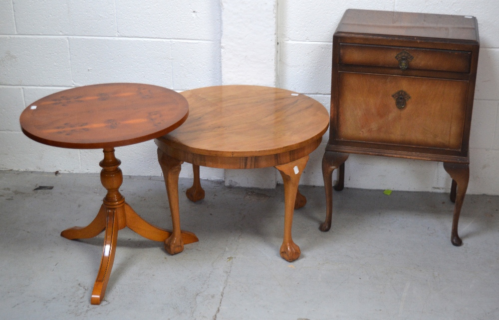 A mid 20th century round walnut side table on cabriole legs and paw feet,
