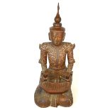 A 20th century carved Balinese temple figure musician, decorated with mirror and glass, height 53cm.